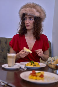 Woman having food at table