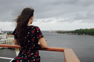 Woman standing on cruise with havana in background