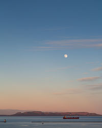 Scenic view of sea against sky at dusk