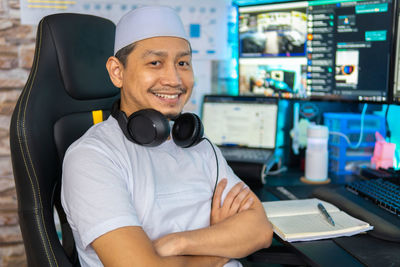 Portrait of smiling man sitting on camera