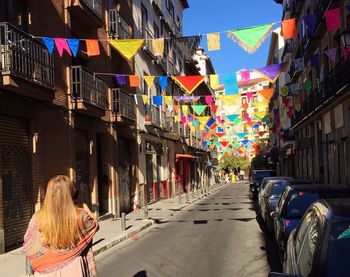 Multi colored flags hanging in city