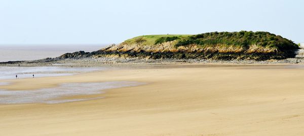 Scenic view of beach against clear sky