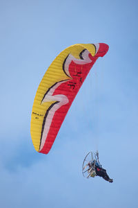 Low angle view of person paragliding