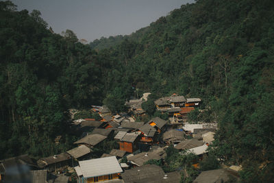 High angle view of houses and trees by mountains