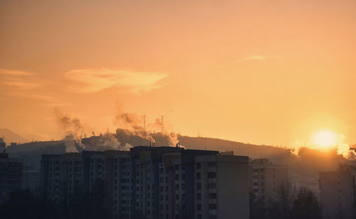 Buildings against sky during sunset