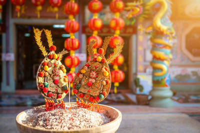Close-up of lit candles in temple