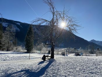 Snow covered land against sky