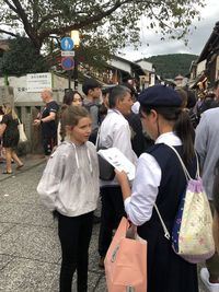 Group of people walking on street in city