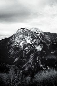 Low angle view of snowcapped mountains against sky