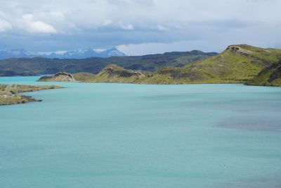 Scenic view of sea and mountains against sky