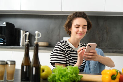 Portrait of young woman using mobile phone