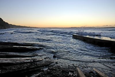 Scenic view of sea against clear sky during sunset