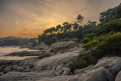 Scenic view of rocks against sky during sunset