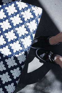 Low section of woman standing on tiled floor