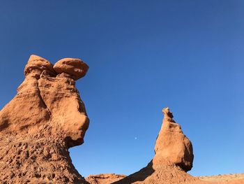 Low angle landscape of blue sky and strange rock formations in goblin valley state park in utah