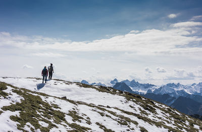 Hiker couple standing on mountain at bavarian alps in germany