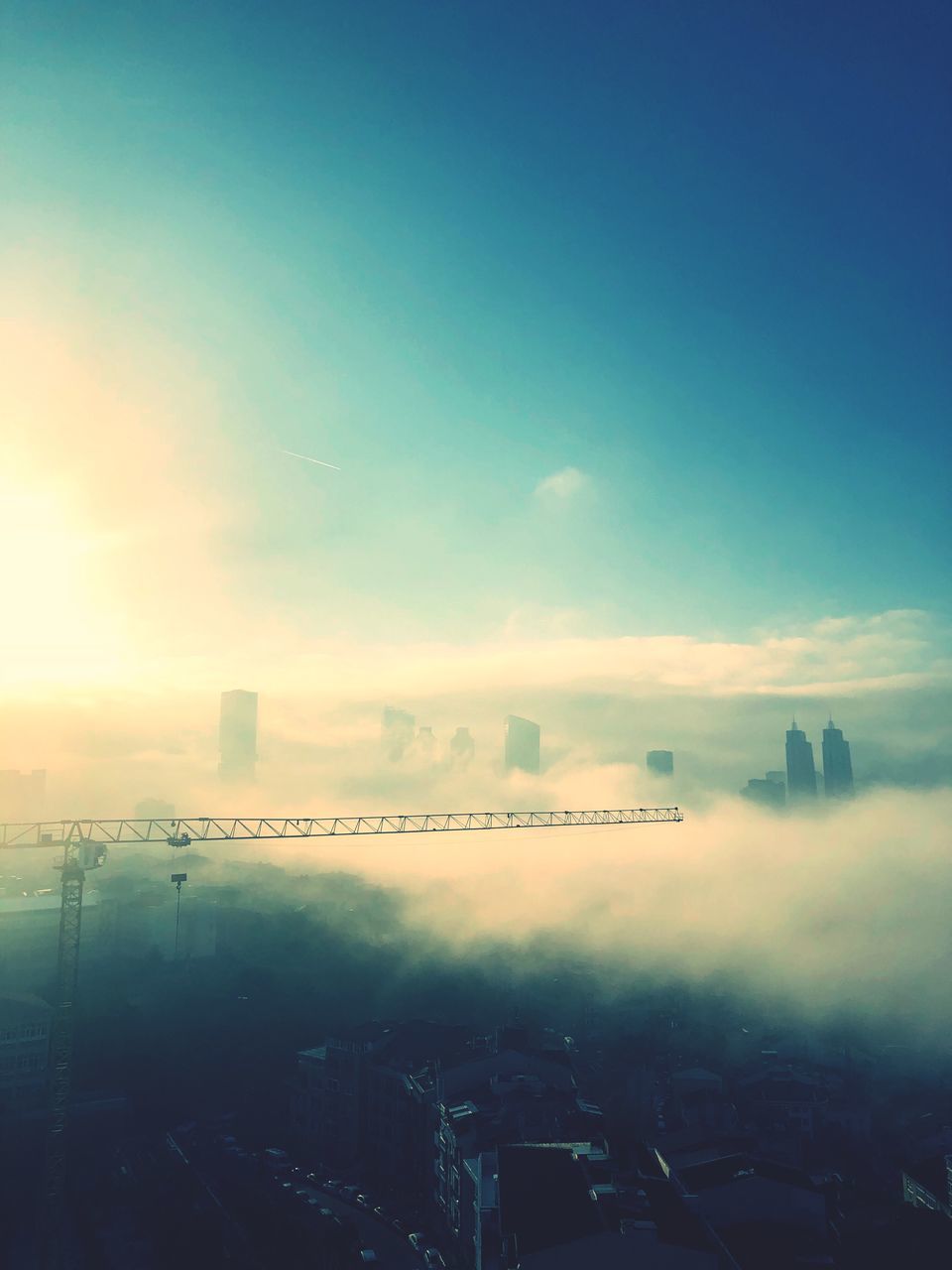 HIGH ANGLE VIEW OF BUILDINGS AGAINST SKY AT SUNSET