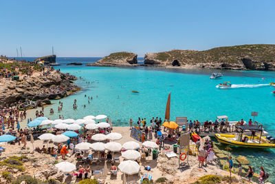 People on beach against clear sky