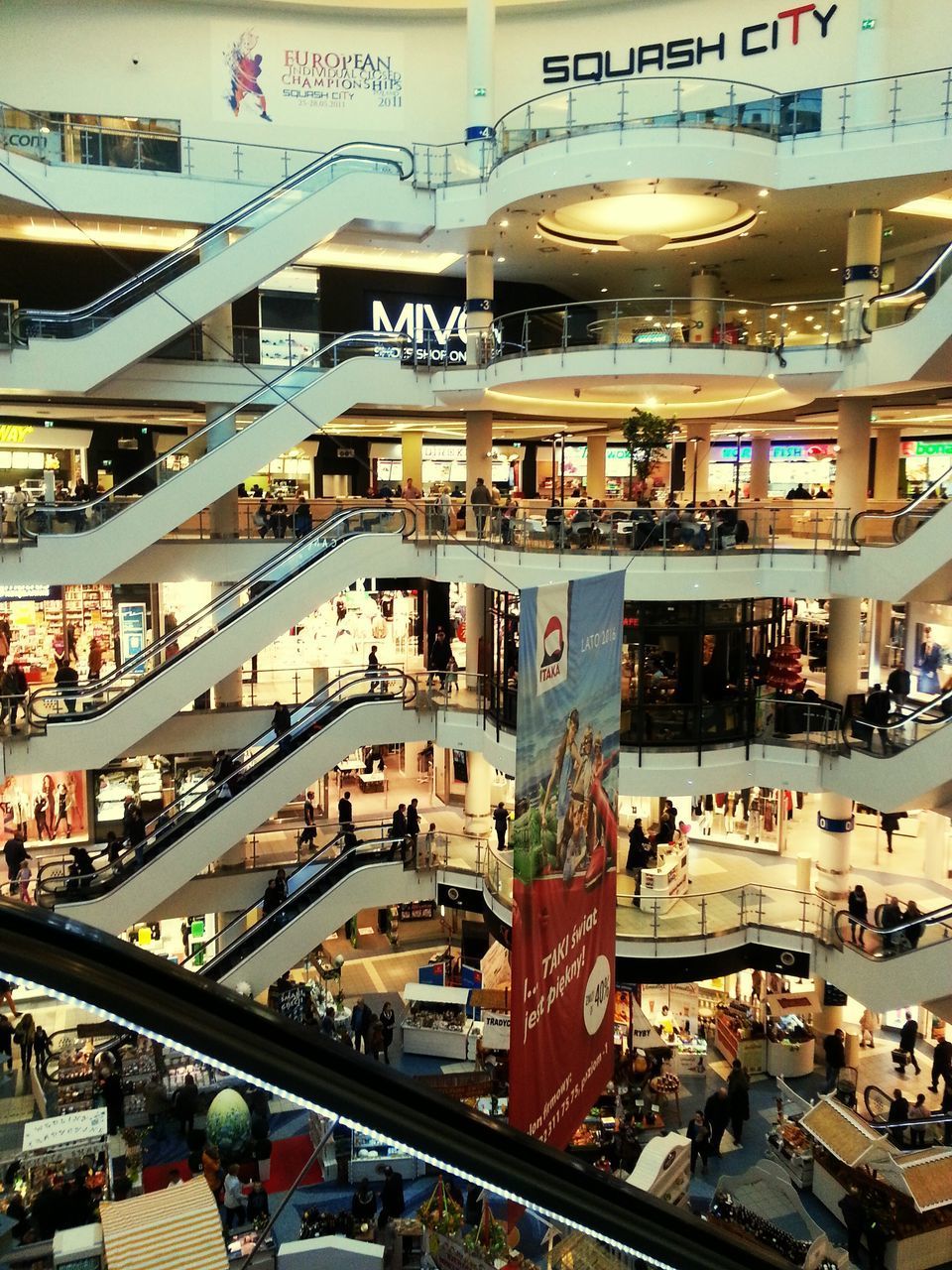 HIGH ANGLE VIEW OF ILLUMINATED STORE IN CITY BUILDINGS