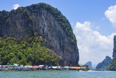 Scenic view of sea and mountains against sky