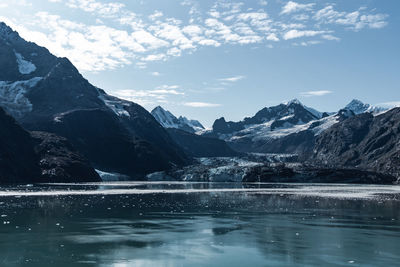 Scenic view of lake and mountains against sky