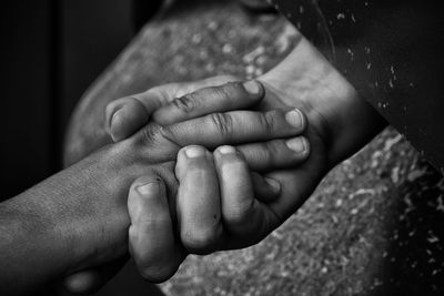 Close-up of people holding hands