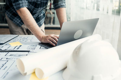 Midsection of man working on table