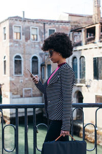 Modern young woman using smartphone