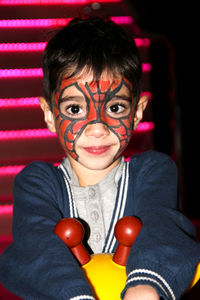 Portrait of boy with face paint at night