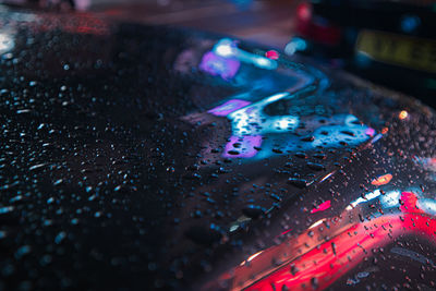 High angle view of raindrops on car 