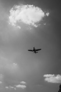 Low angle view of airplane flying in sky