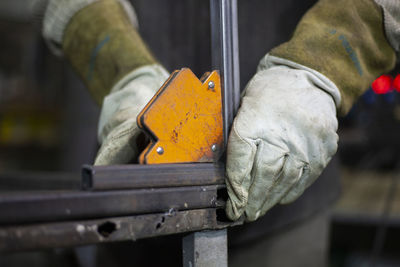 Close-up of man working on metal