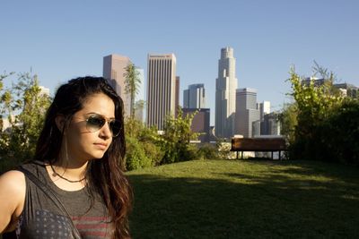 Beautiful woman in park against clear sky