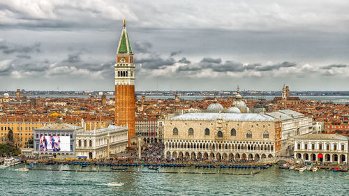 Buildings in city against cloudy sky