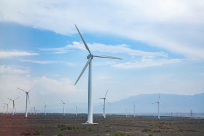 Windmill on field against sky