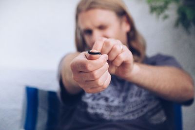 Portrait of man aiming rubber band