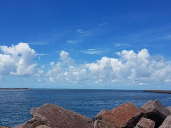 Panoramic view of sea against blue sky