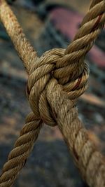 Close-up of rope tied up on metal