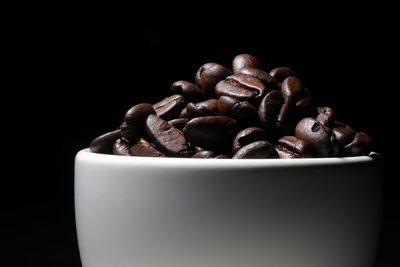 Close-up of coffee beans against black background