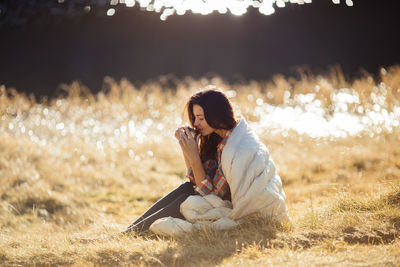 Woman sitting on field