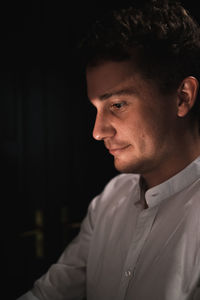 Close-up portrait of young man looking away