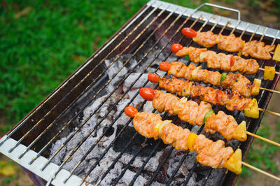 High angle view of meat on barbecue grill