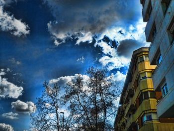 Low angle view of building against cloudy sky