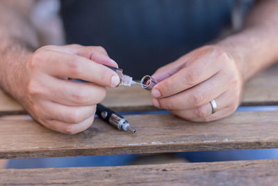 Close-up of hands working on table