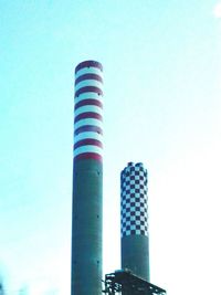 Low angle view of tower against blue sky