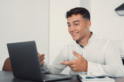 Young man using laptop at office