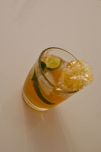Close-up of drink on glass against white background