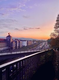 Bridge over river against sky during sunset