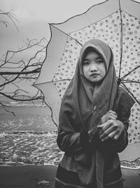 Portrait of young woman standing outdoors