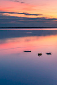 Scenic view of sea against romantic sky at sunset